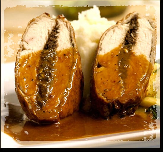Stuffed meat roll cut in two, in sauce with mashed potatoes