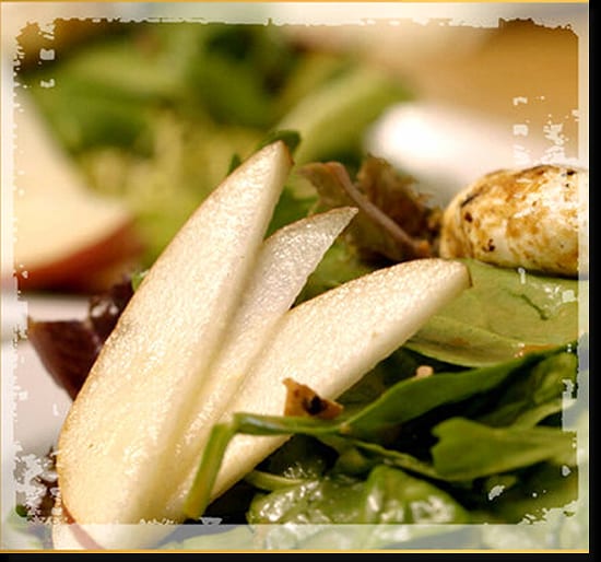 Pear slices fanned over a green salad